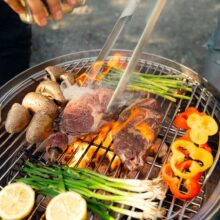 a person is cooking food on a grill