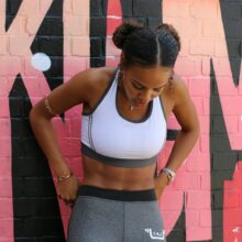 woman in white sports bra and gray sweatpants