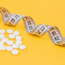white round medication pill on yellow surface